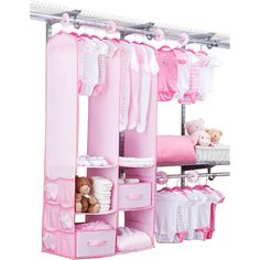 an organized closet for baby's clothes with pink and white accessories hanging from the ceiling