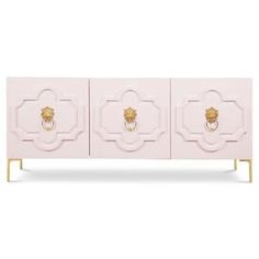 a pink cabinet with gold handles and lion heads on the doors, against a white background