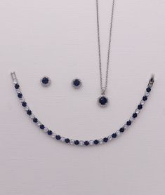 "This dainty jewelry set will surely add sparkle on your special day! Boasting brilliant cubic zirconia in a framed round, classic design with a navy blue sapphire colored cz center stone set in brilliant rhodium plating. Stud earrings measure 8mm. Necklace measures 16\" and has an extender to extend up to 18\" long. This beautiful jewelry comes in a gift box ready for gift giving! Choose from multiple jewelry options. Matching (optional) bracelet measures 7\" and finishes out the look. This set Navy Blue Jewelry Set, Dark Blue Jewelry, Navy Blue Jewelry, Blue Jewelry Set, Blue Wedding Jewelry, Wedding Earrings Studs, Blue Sapphire Jewelry, Silver Jewlery, Logo Jewelry