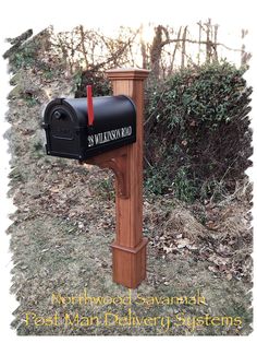 a mailbox in the grass near some bushes