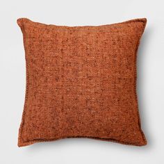 an orange pillow on a white background