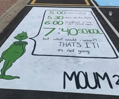 a sign painted on the side of a parking lot that says mom's day