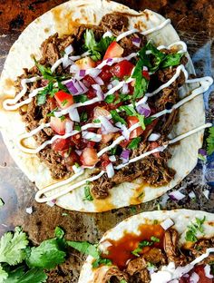 three tacos with meat, onions and tomatoes