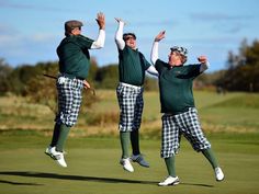 three men jumping in the air on a golf course