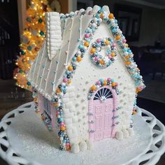 a white cake with a pink door and window