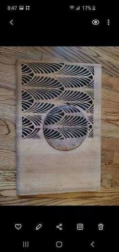 a wooden plaque with an intricate design on it