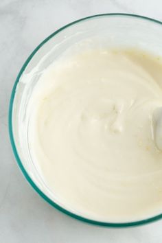 a glass bowl filled with batter on top of a white counter