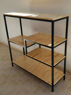 a wooden shelf sitting on top of a tiled floor