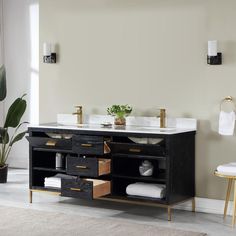 a bathroom vanity with two sinks and gold faucets