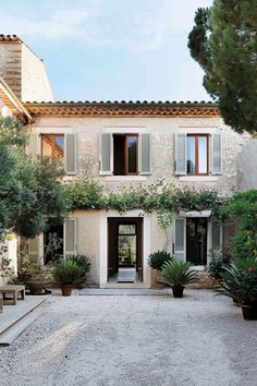 a large house with lots of windows and plants