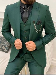 a man with a beard wearing a green suit