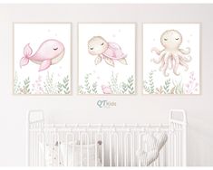 two pink and white paintings on the wall above a crib in a baby's room