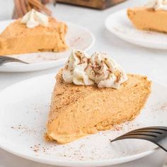 slices of pumpkin pie with whipped cream on top and one slice missing from the pie