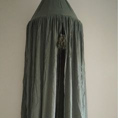 a long green dress hanging on the wall