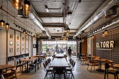 an empty restaurant with wooden tables and chairs