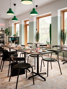 an empty restaurant with tables and chairs in front of large windows