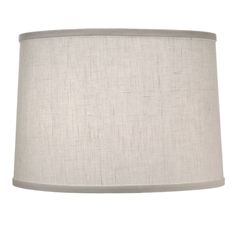 a lamp that is on top of a white table cloth with a light grey shade