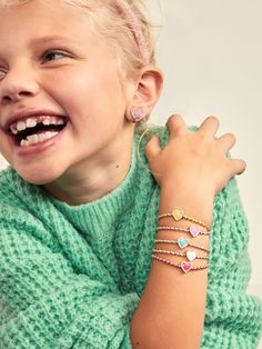 The Sweetheart Kids' Pisa Bracelet Set comes with five unique gold beaded bracelets. Each bracelet is complete with a heart bead in the center in a range of bright colors. Gift as a set to your little one, or split them apart to gift to them and all of their friends. READY TO GIFT: This item comes pre-packaged in a beautiful box.Please note: intended for children 3+ Kids Jewelry Gold, Bracelet Photoshoot, Bracelets Photography, Jewelry For Baby, Valentine's Day Gifts For Kids, Bracelet Photography, Kid Jewelry, Personalized Placemats, Jewelry Mood Board