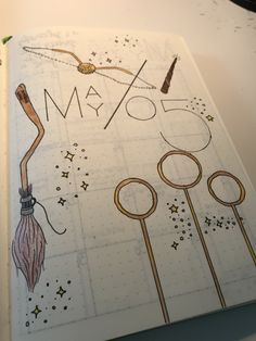 an open planner with scissors and stars on the cover that says may fool in gold lettering