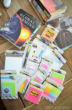 a table topped with lots of books and papers