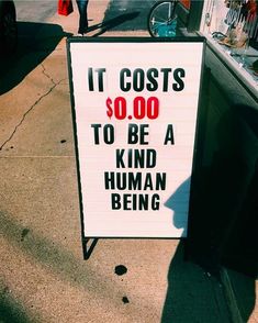 a sign that says it cost $ 10, 000 to be a kind of human being