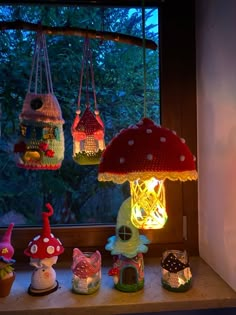 a window sill filled with lots of different types of lights and lamps hanging from it's sides