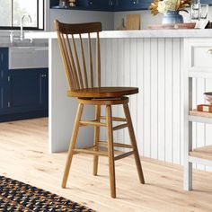 a kitchen with blue cabinets and wooden stools