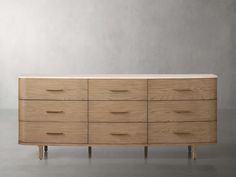 a large wooden dresser sitting on top of a gray floor next to a white wall