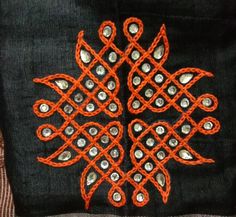 an orange and black piece of cloth with beads on it