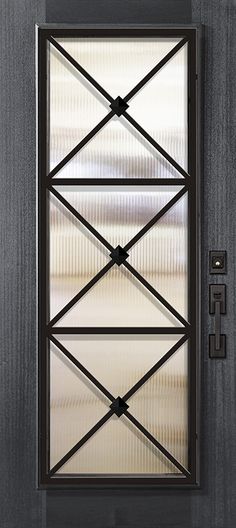 an open door with metal bars on the sides and glass panels above it, in front of a concrete wall