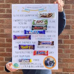 a person holding up a sign with candy on it