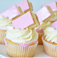 cupcakes with pink and white frosting on a plate