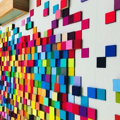 the colorful wall is made up of many different colored squares on it's sides