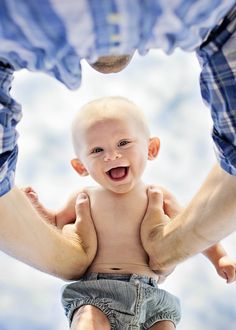 a man holding a baby in his arms with a quote from unknown on the back