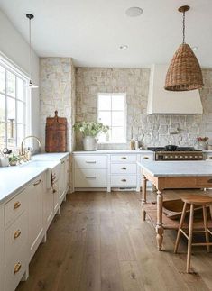 a kitchen with wooden floors and white cabinets