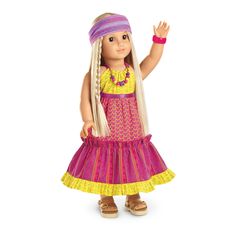 an american girl doll wearing a colorful dress and headband with her hand in the air