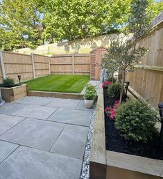 a small backyard with landscaping and trees in it