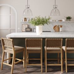 a kitchen with marble counter tops and wooden chairs around a white center island surrounded by potted plants