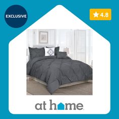 an image of a bed with grey comforter and pillows on the bottom right side