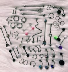 an assortment of various piercings on a white surface