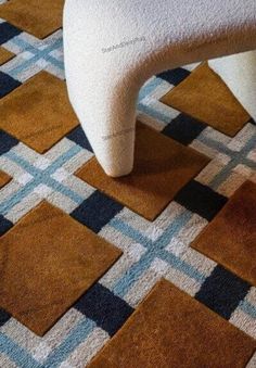 a white chair sitting on top of a checkered floor