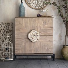 a wooden cabinet sitting next to a bird cage