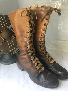 "Fabulous historical boots! Very small shoe size (possibly children's) on a boot that tells a story.  In my research, I found nothing exact and few that came close. This is truly a rare vintage find!  Consider these boots are more than 100 years old! Remarkable condition for the age of the boot.  Some sites claimed that these were Girl Scout boots, while others claimed Hiking Boots. Either way - they're pretty sweet!  Difficult to measure - I was unable to retrieve the inside measurements. Pictu Medieval Boots, Tall Lace Up Boots, Fishing Boots, Old Boots, Old Shoes, Hiking Boots Women, Vintage Boots, Two Piece Dress, Boot Shoes Women