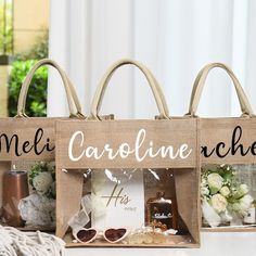 two bags with the words meli caroline rachel on them sitting next to some flowers