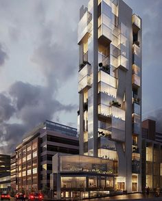 a tall building with many windows and balconies on the top floor at dusk