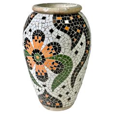 a white vase with orange and black flowers on the outside, sitting in front of a white background