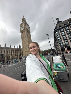 a woman taking a selfie with big ben in the background