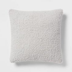 a white pillow sitting on top of a white wall