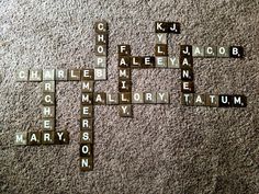 scrabble tiles are arranged in the shape of a cross and words that spell out names