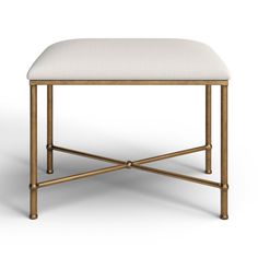 a gold metal stool with a white upholstered cushion on the top and bottom